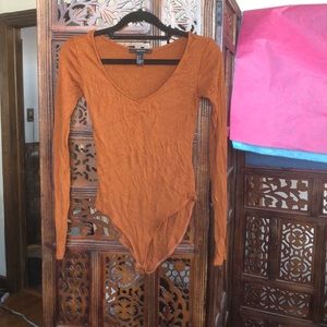 Ribbed burnt orange snap close bodysuit